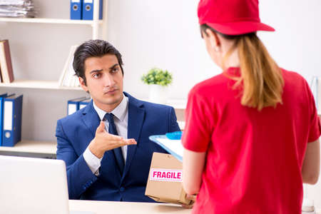 Courier delivering parcel to the office