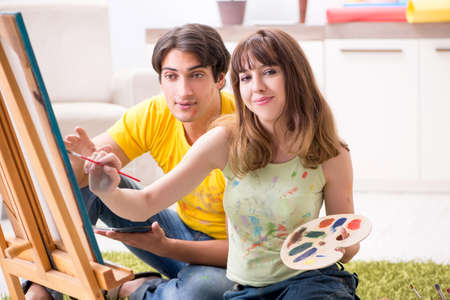 Young couple enjoying painting at homeの写真素材