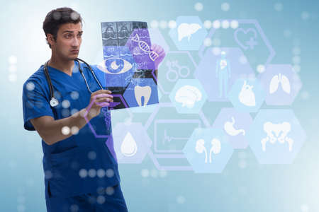 Young doctor looking at x-ray image in mhealth concept