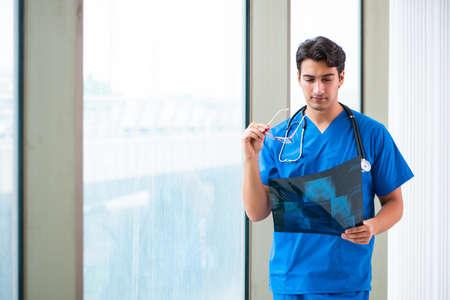 Young handsome doctor working in the hospital