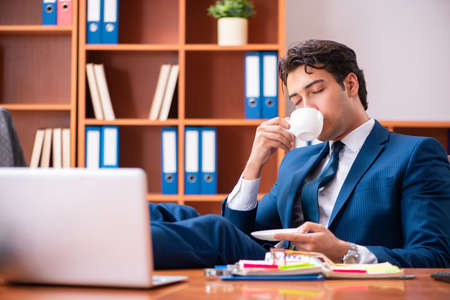 Young handsome businessman working in the officeの写真素材
