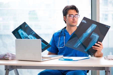 Young handsome doctor working in the hospital