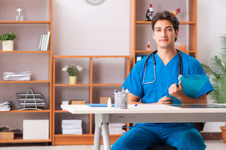 Young handsome doctor radiologyst working in clinicの写真素材