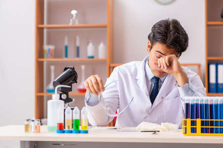 Young handsome biochemist working in the labの写真素材