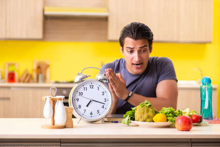 Young man in dieting and healthy eating conceptの写真素材