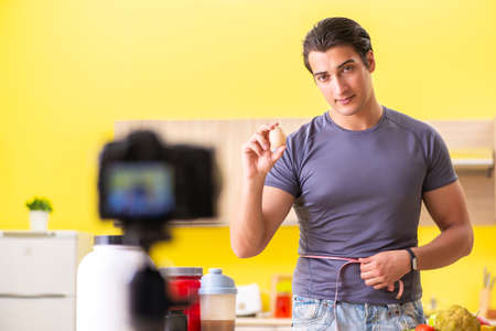 Young man blogging about food supplementsの写真素材