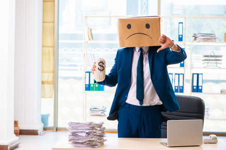 Unhappy man with box instead of his headの写真素材