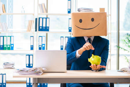 Happy man with box instead of his headの写真素材