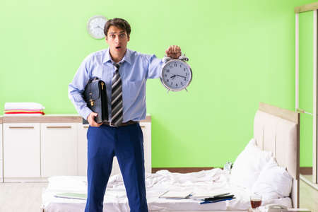 Young businessman employee late for officeの写真素材