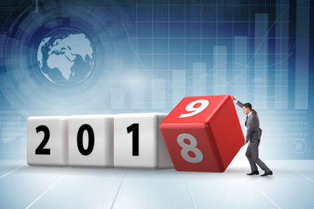 Businessman employee rotating cube to reveal number 2019の写真素材