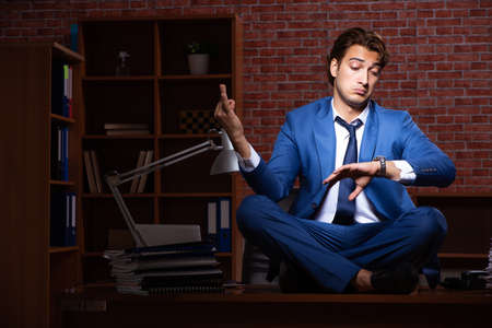 Young businessman working in the office at nightの写真素材