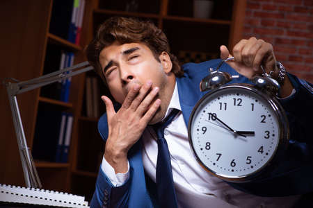 Young businessman working in the office at night