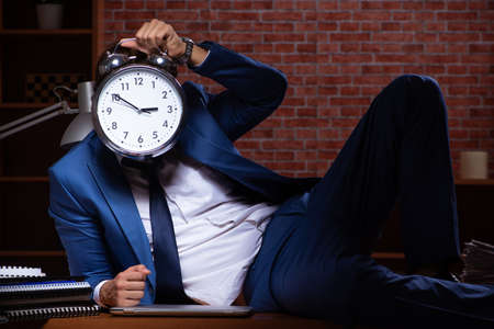 Young businessman working in the office at nightの写真素材