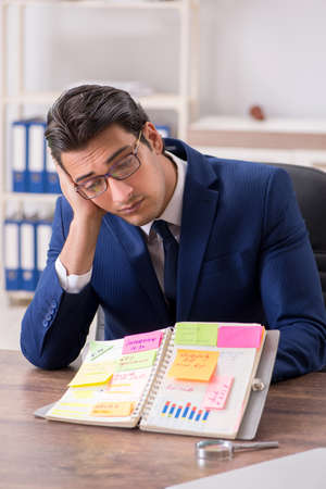 Young handsome employee planning his work activityの写真素材