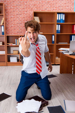 Unhappy businessman sitting in the officeの写真素材