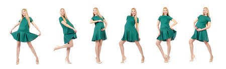 Beautiful pregnant woman in green dress isolated on whiteの写真素材