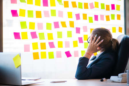 Beautiful female employee with many conflicting prioritiesの写真素材