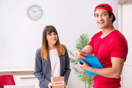 Courier delivering parcel to the officeの写真素材