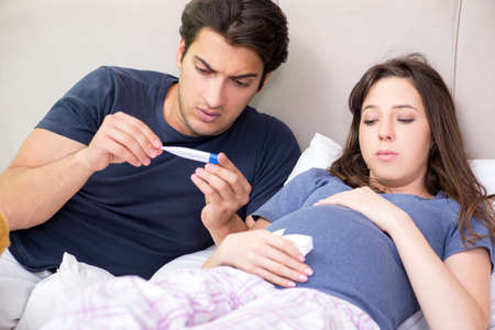 Young husband looking after his pregnant wifeの写真素材