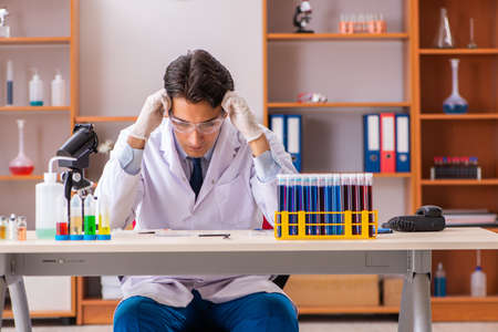 Young handsome biochemist working in the labの写真素材