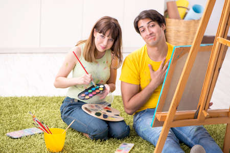Young couple enjoying painting at homeの写真素材