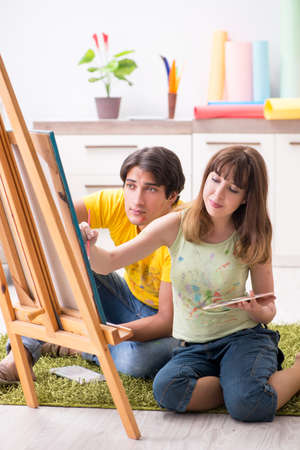 Young couple enjoying painting at homeの写真素材
