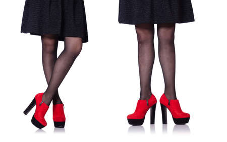 Woman legs with red shoes isolated on the whiteの写真素材