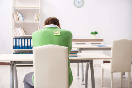 Office prank with kick me message on sticky noteの写真素材