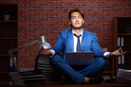 Young businessman working in the office at nightの写真素材