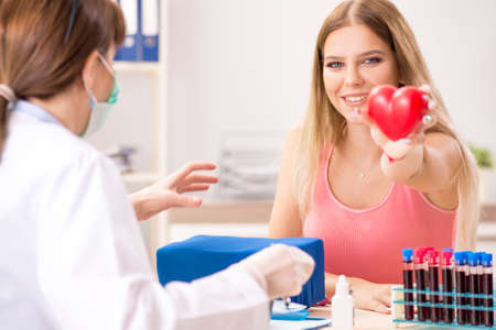 Young beautiful woman during blood test sampling procedureの写真素材