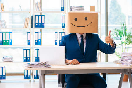 Happy man with box instead of his headの写真素材