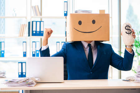 Happy man with box instead of his headの写真素材