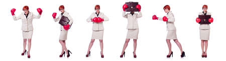 Woman businesswoman with boxing gloves on whiteの写真素材