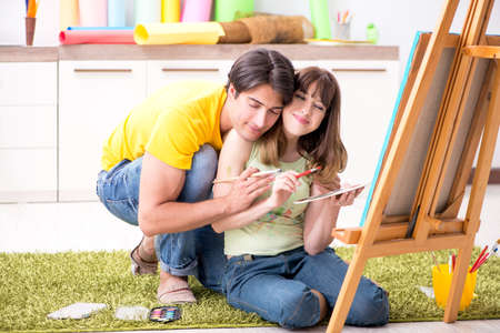 Young couple enjoying painting at homeの写真素材
