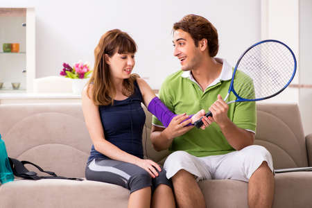 Man and woman discussing elbow strapの写真素材