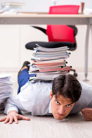 Extremely busy employee working in the officeの写真素材