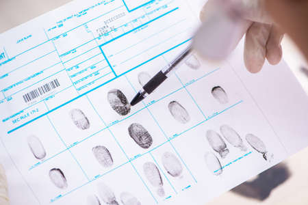 Forensic expert studying fingerprints in the labの写真素材