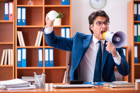 Young handsome businessman working in the officeの写真素材