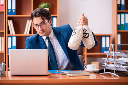 Young handsome businessman working in the officeの写真素材