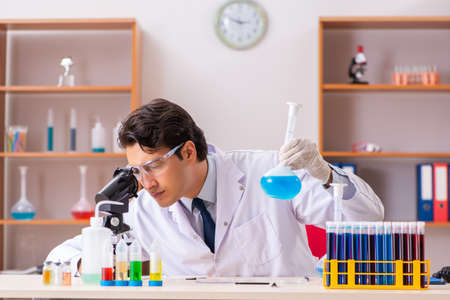 Young handsome biochemist working in the labの写真素材