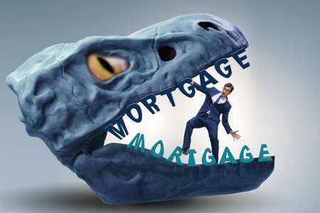 Businessman in the jaws of debt and loanの写真素材