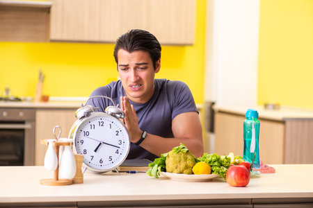 Young man in dieting and healthy eating conceptの写真素材
