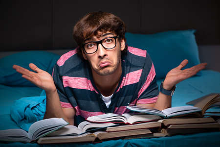 Young student preparing for exams at night at home