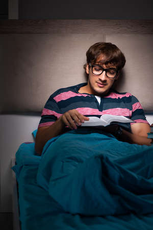 Young student preparing for exams at night at homeの写真素材