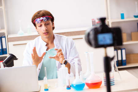 Chemist blogger recording video for his blogの写真素材