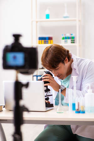 Chemist blogger recording video for his blogの写真素材
