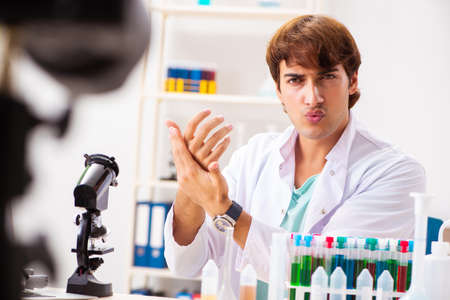Chemist blogger recording video for his blogの写真素材
