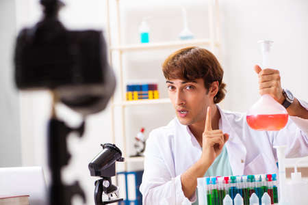Chemist blogger recording video for his blogの写真素材