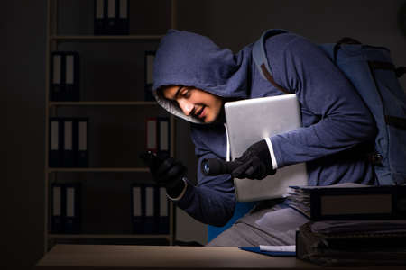 Thief trying to steal personal data in identity theft conceptの写真素材