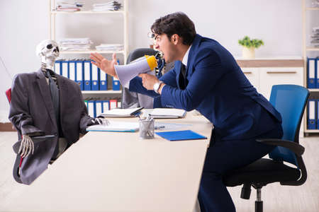 Funny business meeting with boss and skeletonsの写真素材